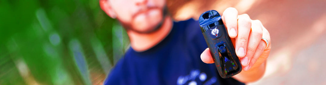 Man holding Sutra Mini in front of teal and purple studio background